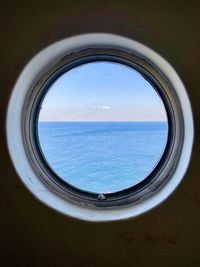 Scenic view of sea against sky seen through window