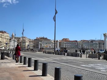 Buildings in city against clear blue sky