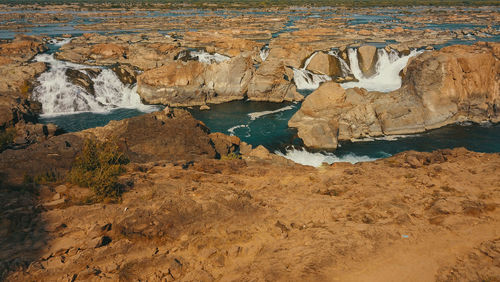 View of rock formations in sea