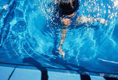 Man swimming in pool