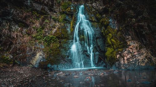 Water flowing through rocks in forest