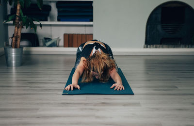 Yogic woman practicing in yoga studio