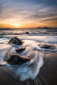 Scenic view of sea against sky during sunset