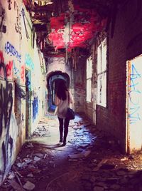 Full length of woman standing in front of building