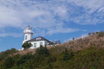 Low angle view of building on hill against sky