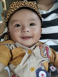 Close-up portrait of smiling boy at home