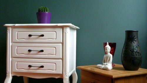 White cabinet and buddha figurine at home