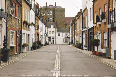 Road amidst buildings in city