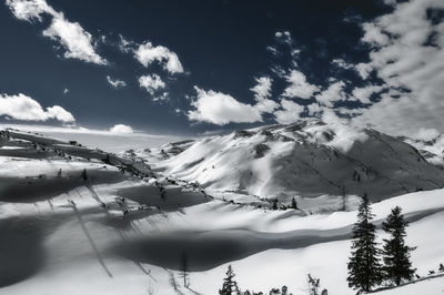 Scenic view of snow covered mountains against sky