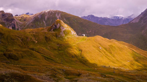 Scenic view of mountains against cloudy sky