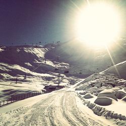 Road passing through snow covered landscape