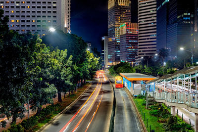 Light trails on road in city at night