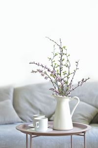 Close-up of white flower vase on table at home