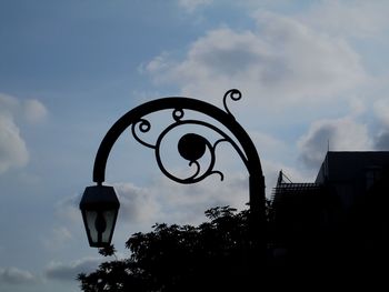 Low angle view of building against cloudy sky