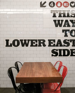 Text on chair against wall