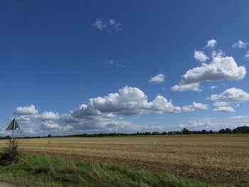 Scenic view of field against blue sky