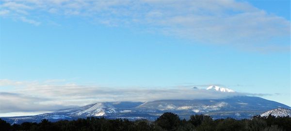 Scenic view of mountains against sky during winter