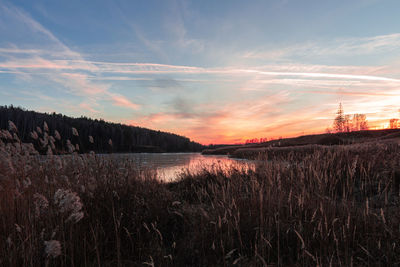 Scenic view of lake against sky during sunset