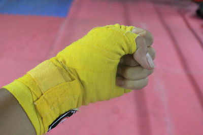 Close-up of hand holding yellow leaf
