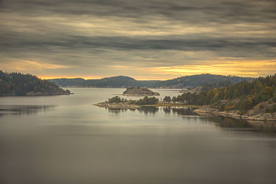 Scenic view of lake against sky during sunset
