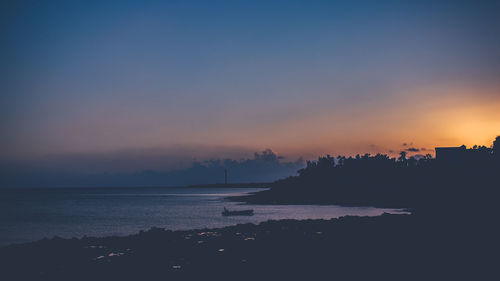 Scenic view of sea against sky at sunset