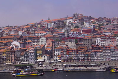 View of townscape by sea against sky