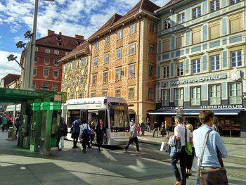 People walking in front of buildings