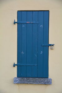 Closed door at window on building