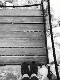 Low section of person standing on wood