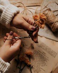 High angle view of woman hand holding book