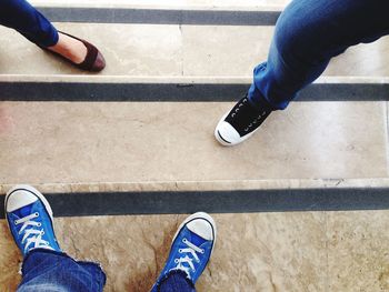 Low section of man standing on tiled floor