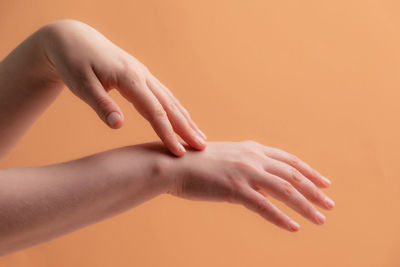 Close-up of woman hand against gray background