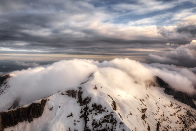 Scenic view of snow covered mountains against sky