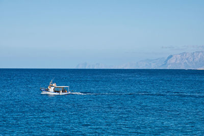 Sailboat sailing on sea against sky