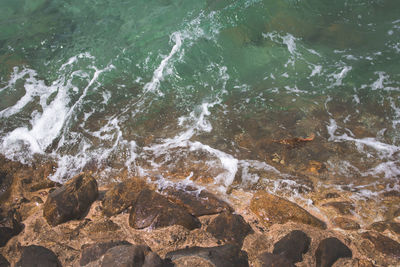 High angle view of rocks in sea