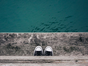 Ground shot of shoes on dock ontop of sea