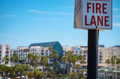 Close-up of fire lane signboard against sky