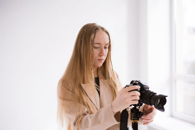 Young woman photographing with camera