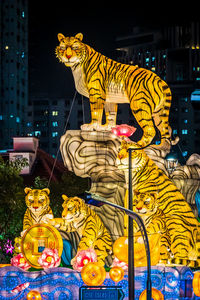 Side view of giraffe at night