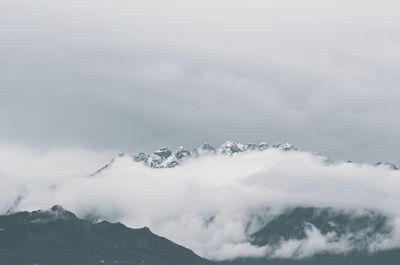 Low angle view of snowcapped mountains against sky