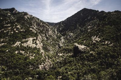 Low angle view of rocky mountains against sky
