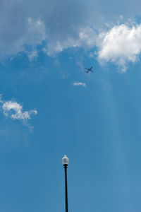 Low angle view of airplane flying in sky