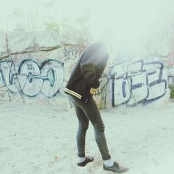 Woman standing in graffiti