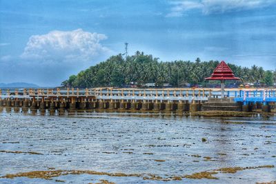 Scenic view of river by building against sky