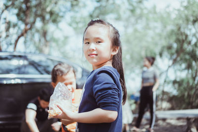 Side view of mother and daughter outdoors