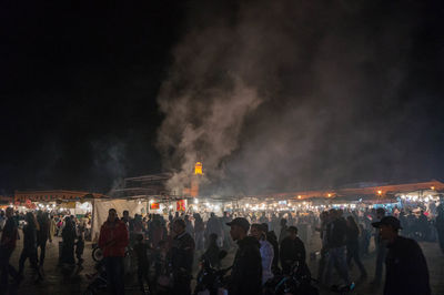 Group of people against sky at night