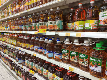 Panoramic shot of bottles on display at store