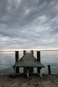 Lifeguard hut on beach against sky