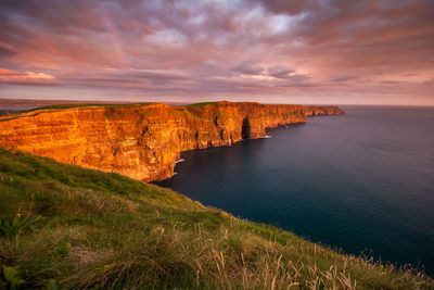 The iconic cliffs of moher at sunset on the west coast of ireland