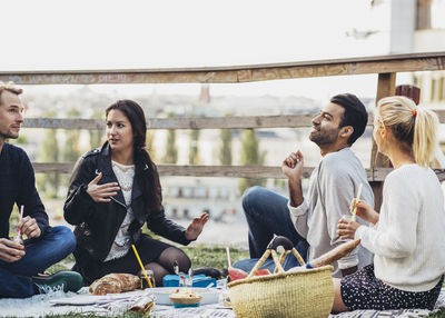 Multi-ethnic friends enjoying party at roof garden